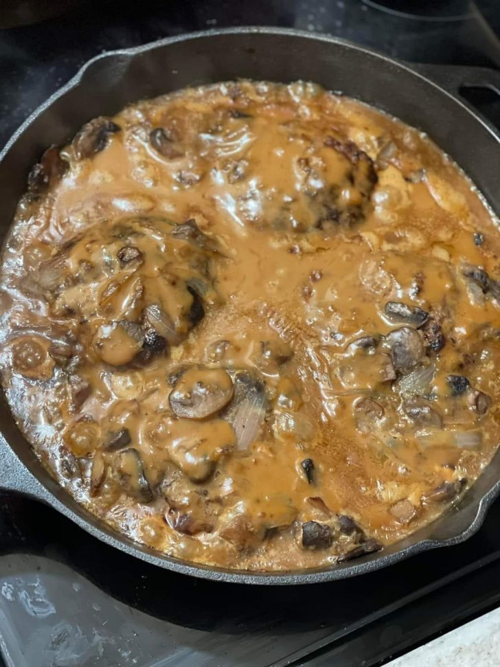 Hamburger steak smothered in brown gravy with mushrooms and onions ...